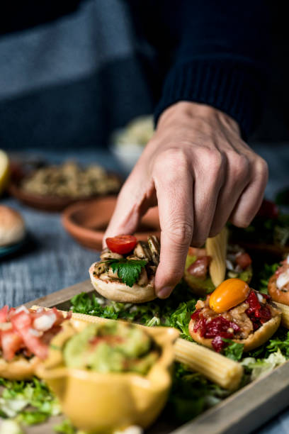 istock young man takes a vegan appetizer from a tray 1311420508