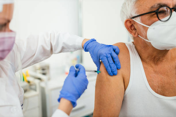 istock Doctor applying a vaccine on a man's arm 1311421676