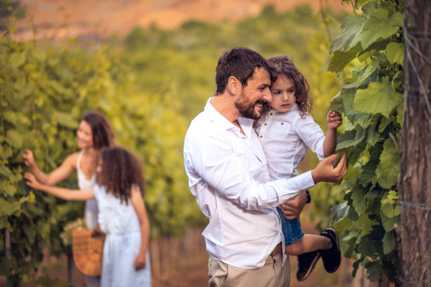 istock Family in the vineyard. Focus is on foreground. 1311424291