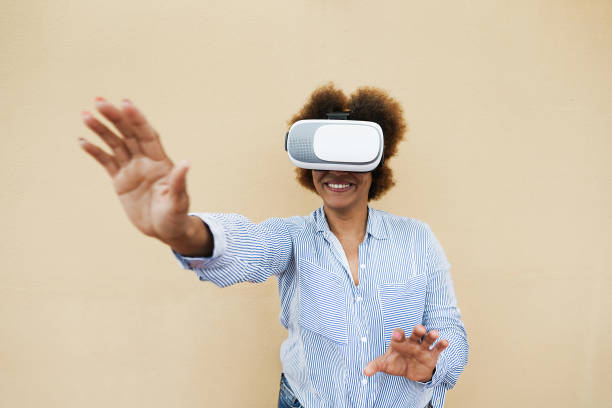 istock Senior african woman using virtual reality headset - Technology trend and joyful elderly lifestyle concept -  Focus on vr googles 1311424855