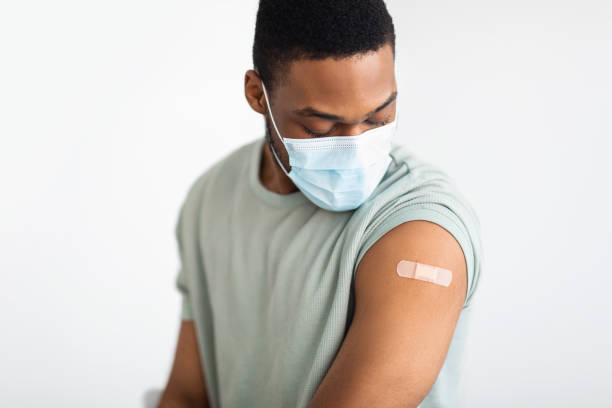 istock Vaccinated Man Looking At Arm With Injection Plaster, White Background 1311427203