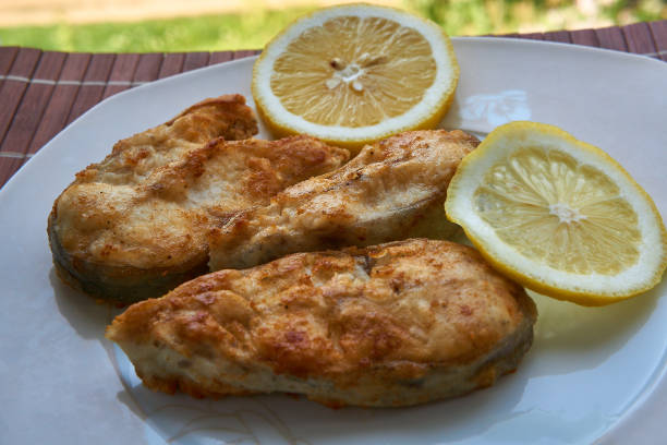 istock Pieces of fried fish with lemon wedges. 1311428500