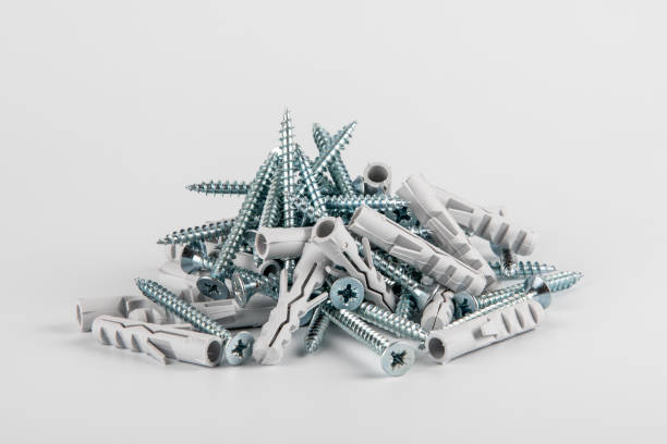 istock Screws with plastic dowels on a white background 1311428783
