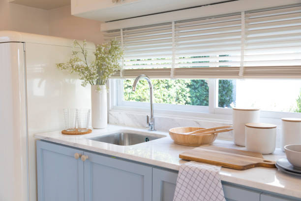 istock Clean new sink in stylish kitchen interior by the window. 1311428833