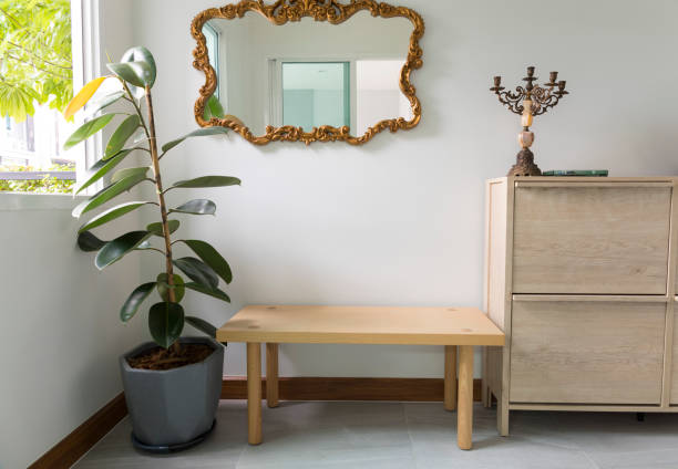istock Modern hallway interior with mirror on wall and wood chair. 1311428847
