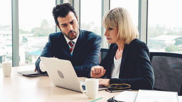 istock Two business people talk project strategy at office 1311430421