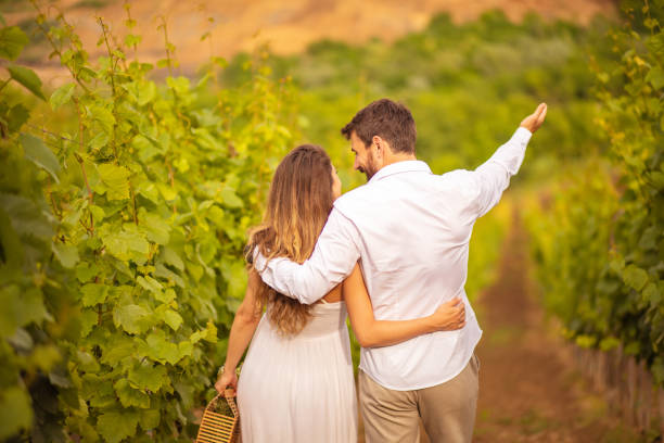 istock Couple walking and talking in vineyard. 1311430515