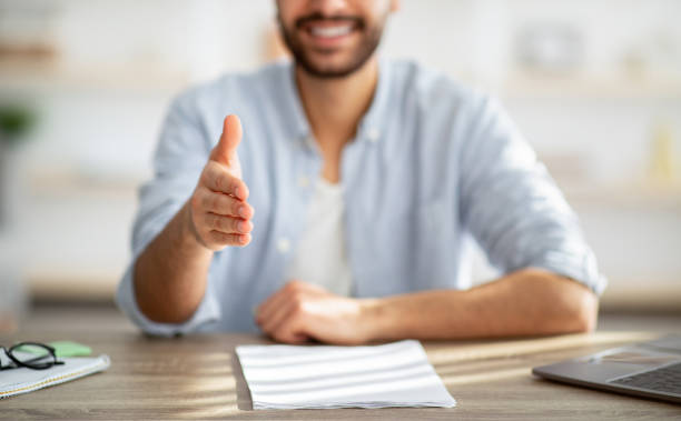 istock Handshake gesture. Unrecognizable positive bearded nan stretching hand for greeting. Job interview concept 1311430640