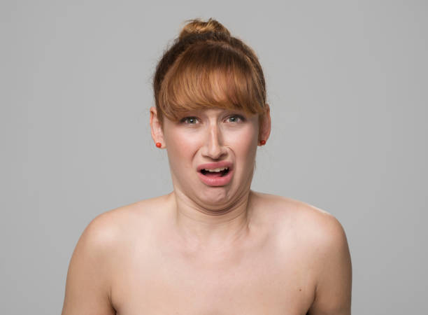 istock Woman crying against grey background 1311432191