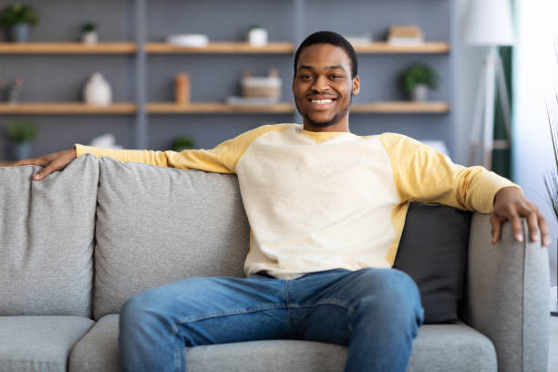 istock Relaxed african american man resting on sofa at home 1311432278