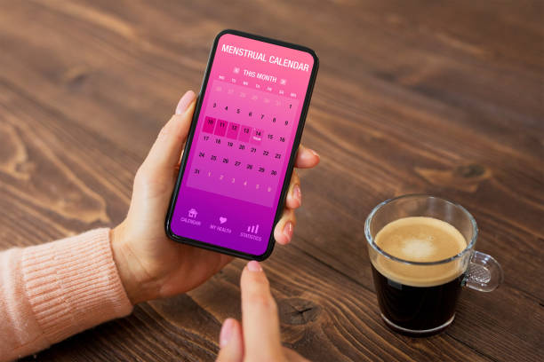 Woman using menstrual calendar app on mobile phone Female using menstrual calendar app on mobile phone menstruation stock pictures, royalty-free photos & images