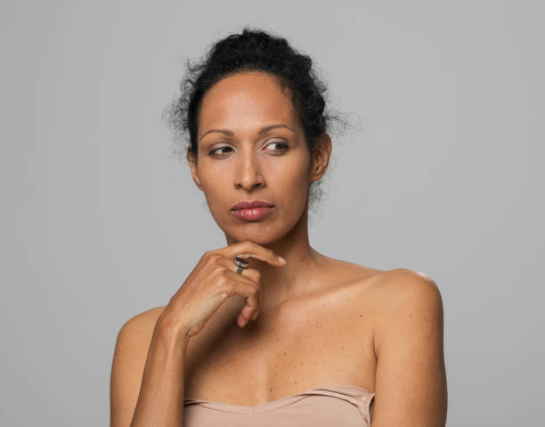 istock Mature woman with hand on chin 1311432489