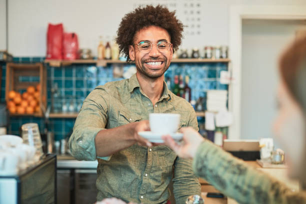 istock A barista serving coffee in a shop 1311433455