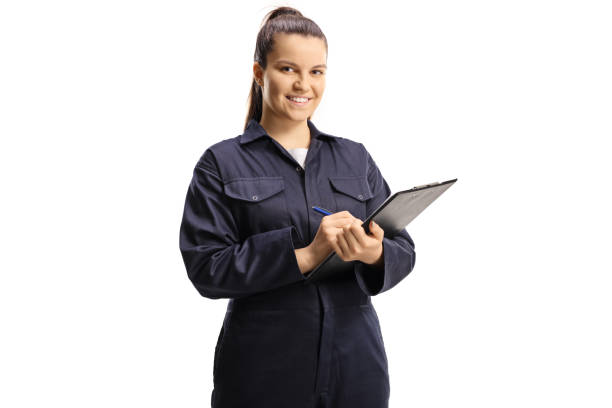 istock Female technician worker in a uniform holding a clipboard 1311433526