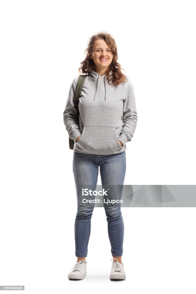 Full length portrait of a female student standing and smiling at the camera Full length portrait of a female student standing and smiling at the camera isolated on white background Teenager Stock Photo
