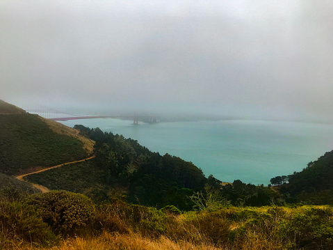 Golden Gate View Point (Old Conzelman Road, Mill Valley CA--photo was taken at 12:38 PM)  is an iconic tourist destination overlooking the famous Gold Gate Bridge. The fog is rolling in and obscuring downtown San Fransisco