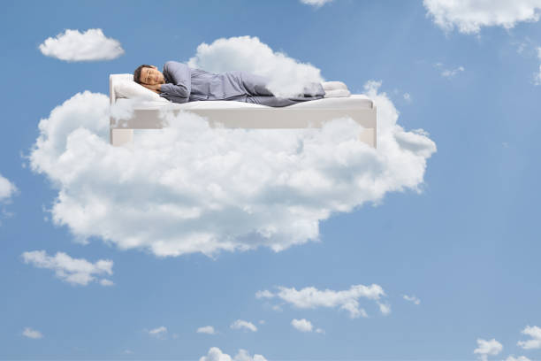 istock Man sleeping peacefully up in the clouds 1311434714