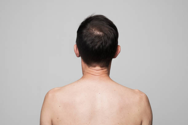 istock Shirtless man standing against grey background 1311434763
