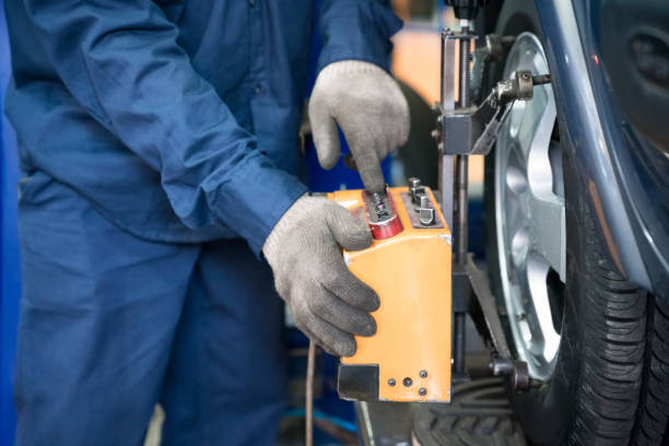 istock Car mechanic balancing wheels 1311435022