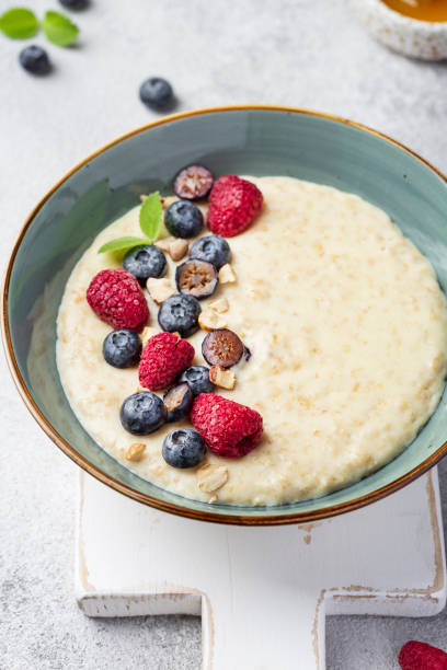 istock oatmeal with berries in bowl on white background 1311435852