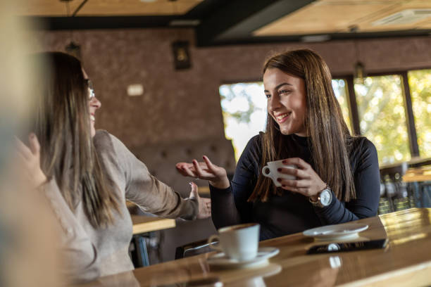 istock Two cheerful women having fun during a coffee in a cafe. 1311436463
