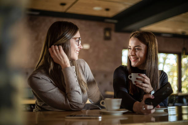 istock Two cheerful women having fun during a coffee in a cafe. 1311436464