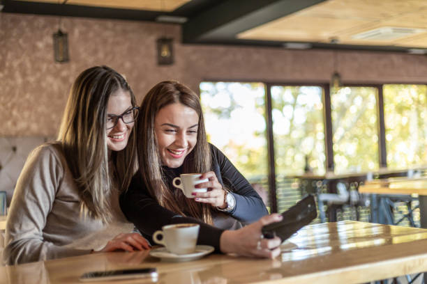 istock Two cheerful women having fun during a coffee in a cafe. 1311436485