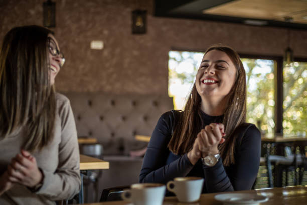 istock Two cheerful women having fun during a coffee in a cafe. 1311436903