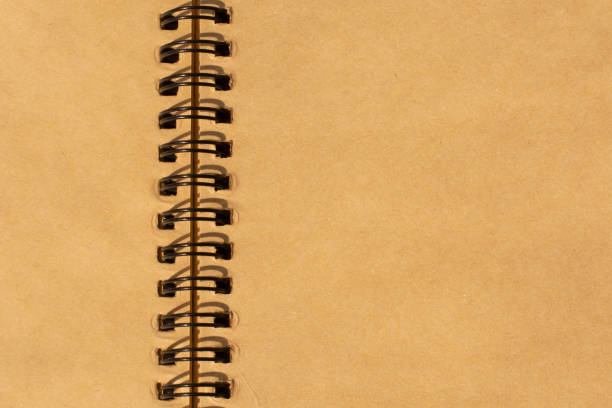 istock blank paper scrap book. close up shot. Recycled paper notebook. Unfolded ring book. 1311436910