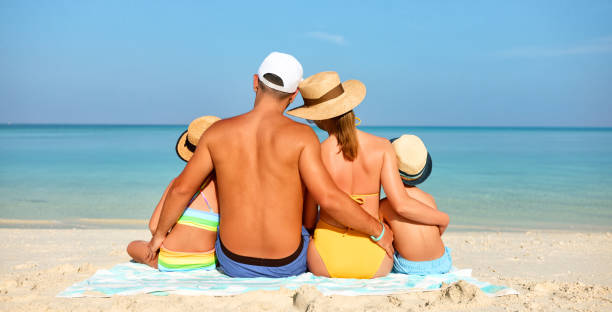 istock Loving family resting on exotic seashore 1311437153