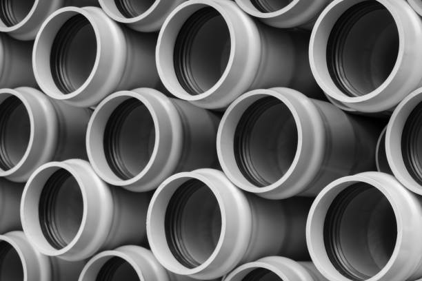istock Stack of stored new PVC plastic pipes on the construction site 1311437356