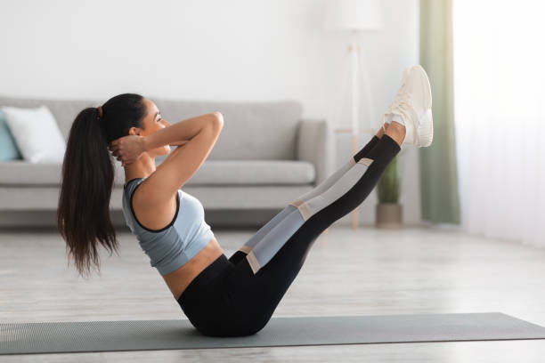 istock Side view of well fit lady training at home 1311438131