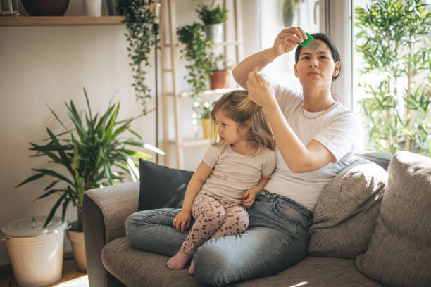 istock Mother doing head lice cleaning on daughter 1311438168