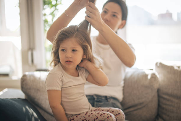 istock Mother doing head lice cleaning on daughter 1311438187