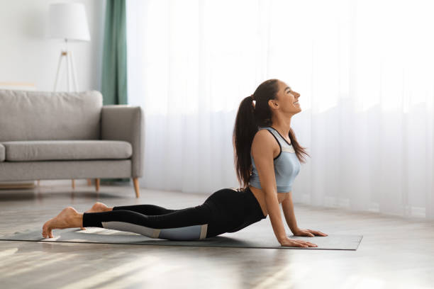 istock Healthy young woman practicing yoga at home 1311438334