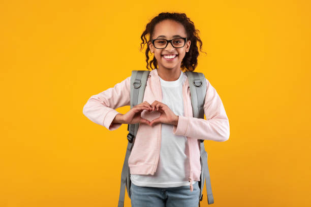 istock Cheerful beautiful girl making heart by hands at studio 1311438357