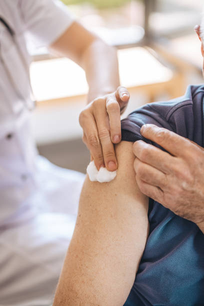 istock Doctor preparing patient's arm for vaccine 1311438389