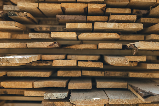 Stacked plates of wood in warehouse, close up