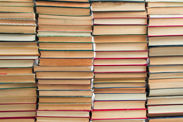 istock Stack of artistic old books stacked on white background 1311439993