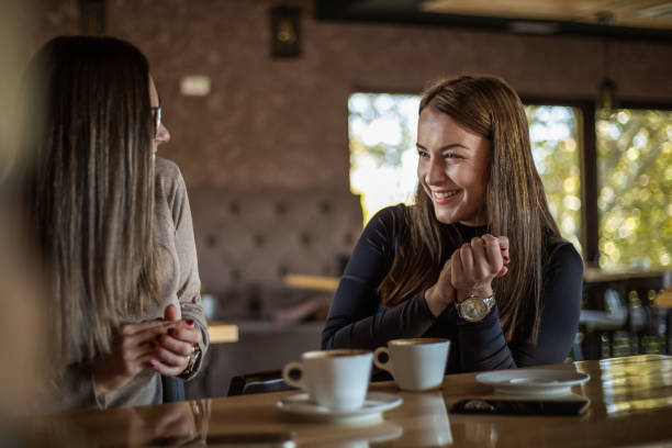 istock Two cheerful women having fun during a coffee in a cafe. 1311440222