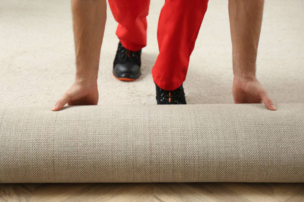 istock Worker rolling out new carpet flooring indoors, closeup 1311441670