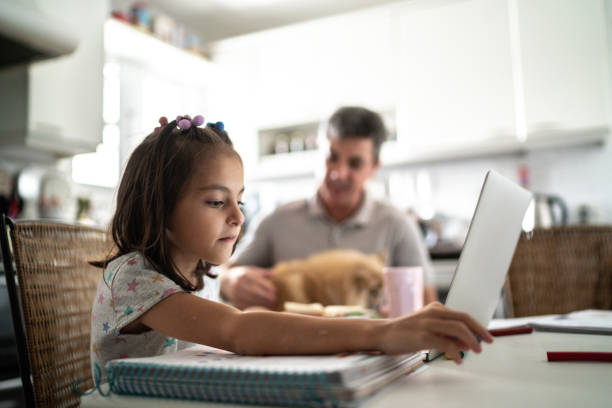 istock Father helping daughter with homework 1311442618