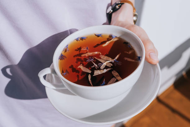 istock White cup of herbal tea with a saucer 1311442897