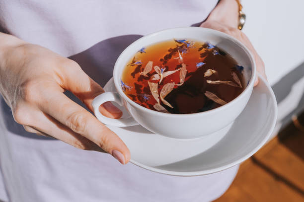 istock White cup of herbal tea with a saucer 1311442904