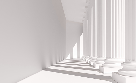 Classical white columns in a row casting shadows on a wall. Abstract architecture resembling a government building dedicated to law, justice and education. Digital image.