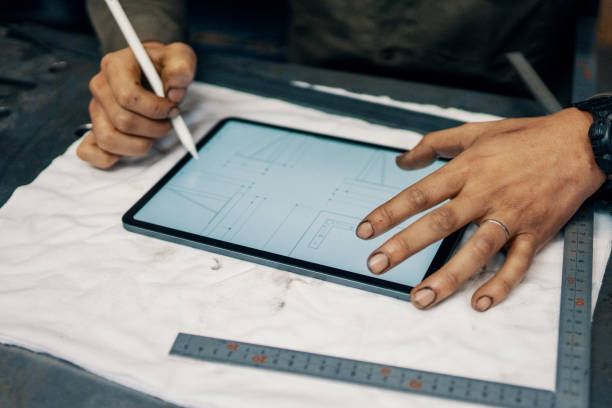 istock Mid adult male using a digital tablet in the manufacturing process 1311447668