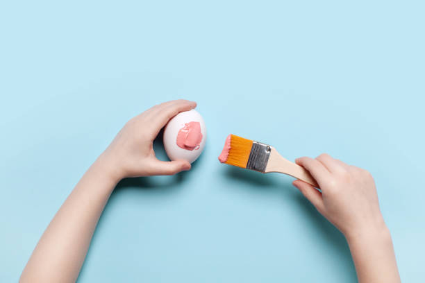 istock The child painted with pink paint an Easter egg 1311450232