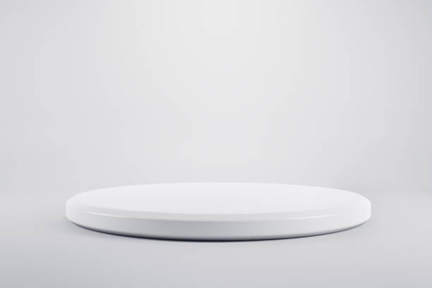 istock Blank round glossy white stand on light grey backdrop. 3D rendering, mock up 1311450286