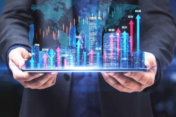 istock Real estate market index concept with developer and virtual financial chart growing arrows on night city buildings background on digital tablet 1311450574