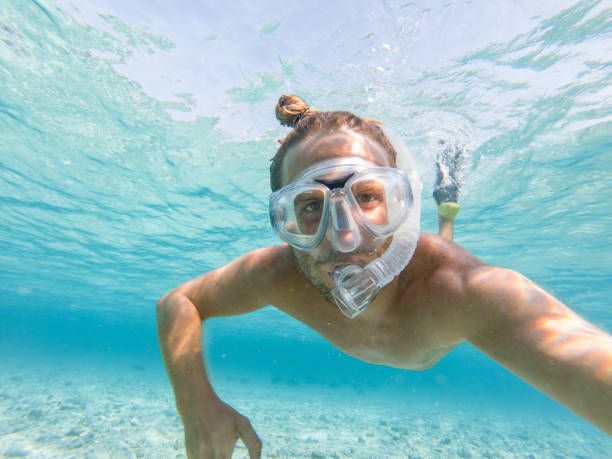 istock Young man takes selfie underwater with snorkelling mask 1311452251